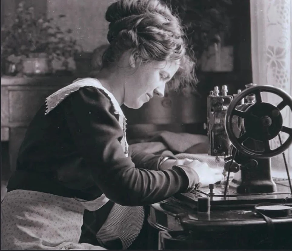 Costurera trabajando con una máquina de coser antigua